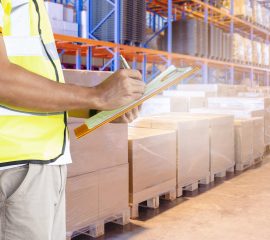 worker-hand-holding-clipboard-inventory-cargo-management-in-storage-warehouse