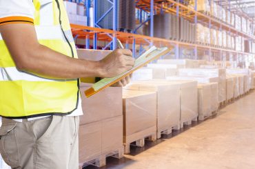 worker-hand-holding-clipboard-inventory-cargo-management-in-storage-warehouse